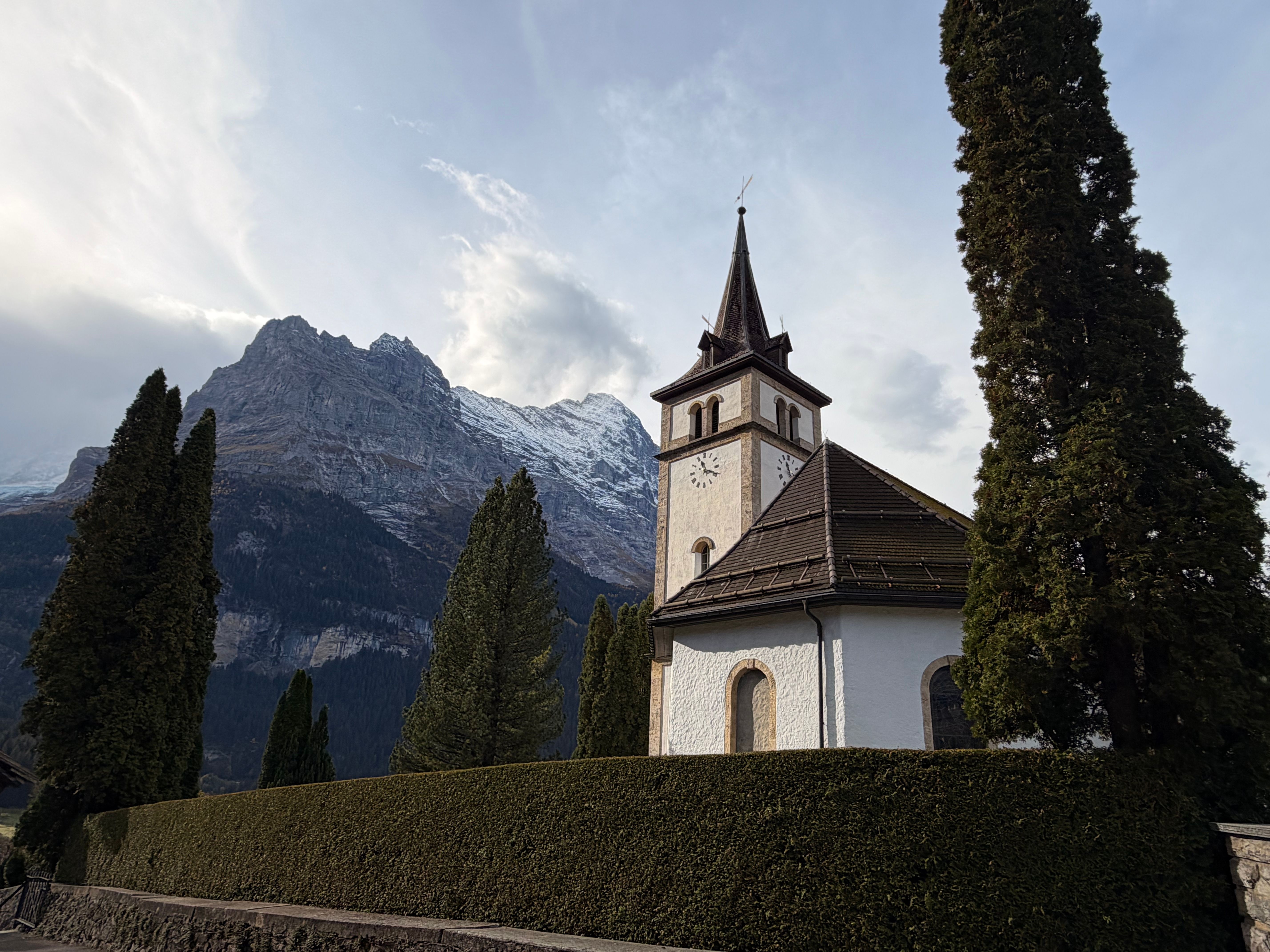 Swiss Alpine Church with Mountainous Backdrop · Free Stock Photo