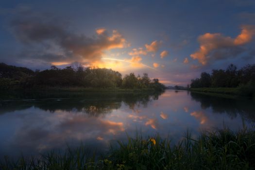 Tranquil sunset reflecting over the River Sile, capturing nature's serene beauty in Veneto, Italy.