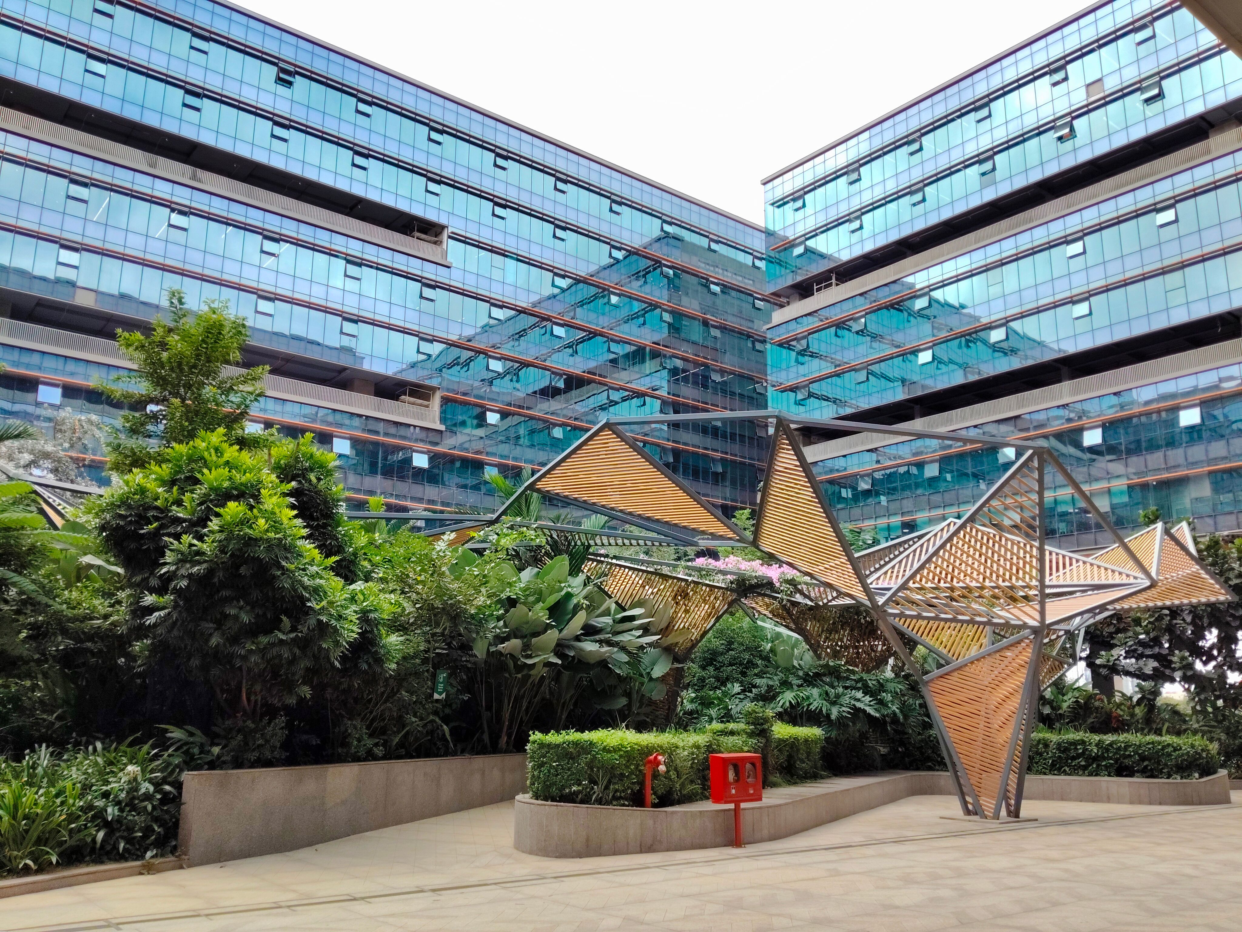 Modern Glass Building with Geometric Structure · Free Stock Photo