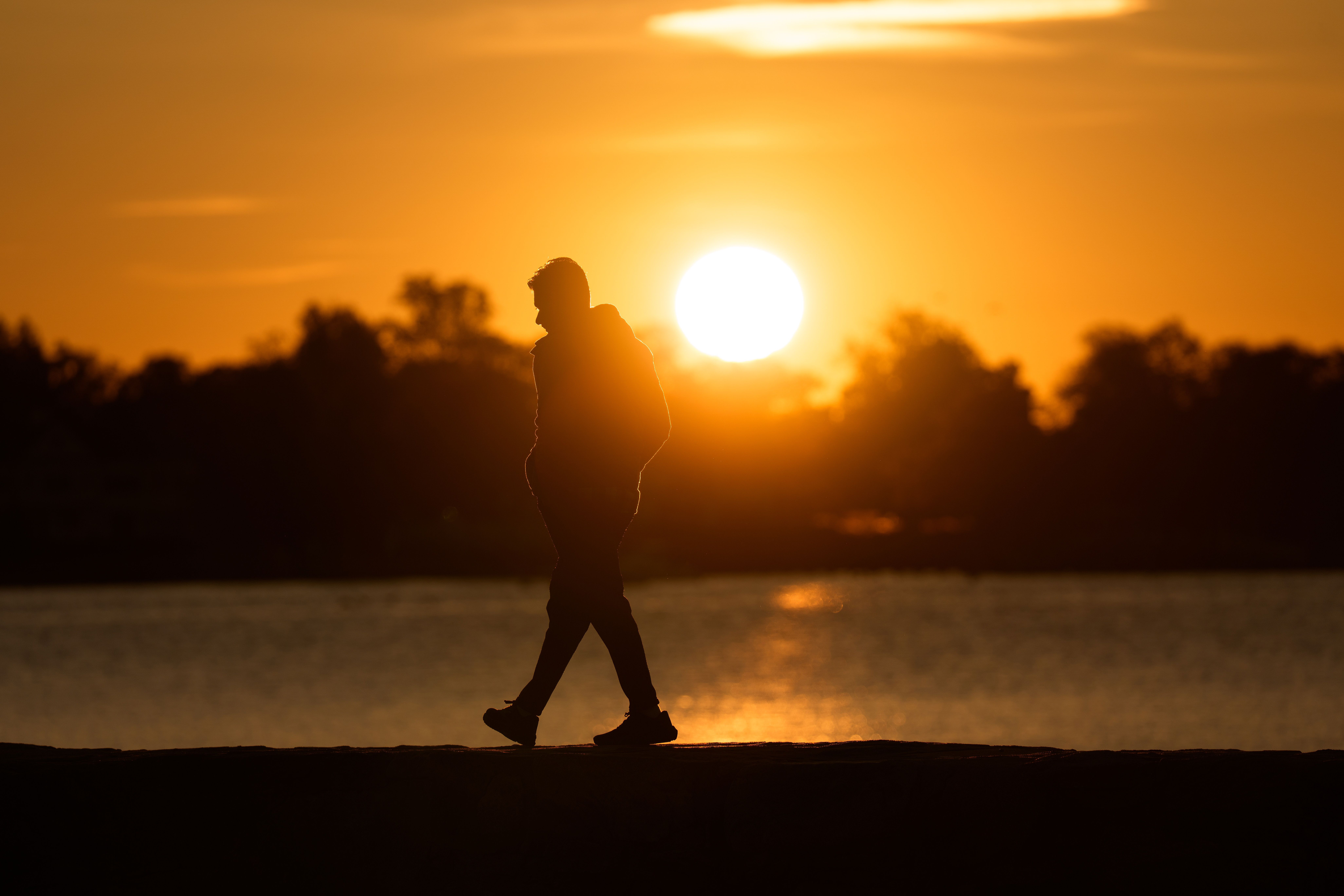 person walking in nature without phone, golden hour, contemplative mood