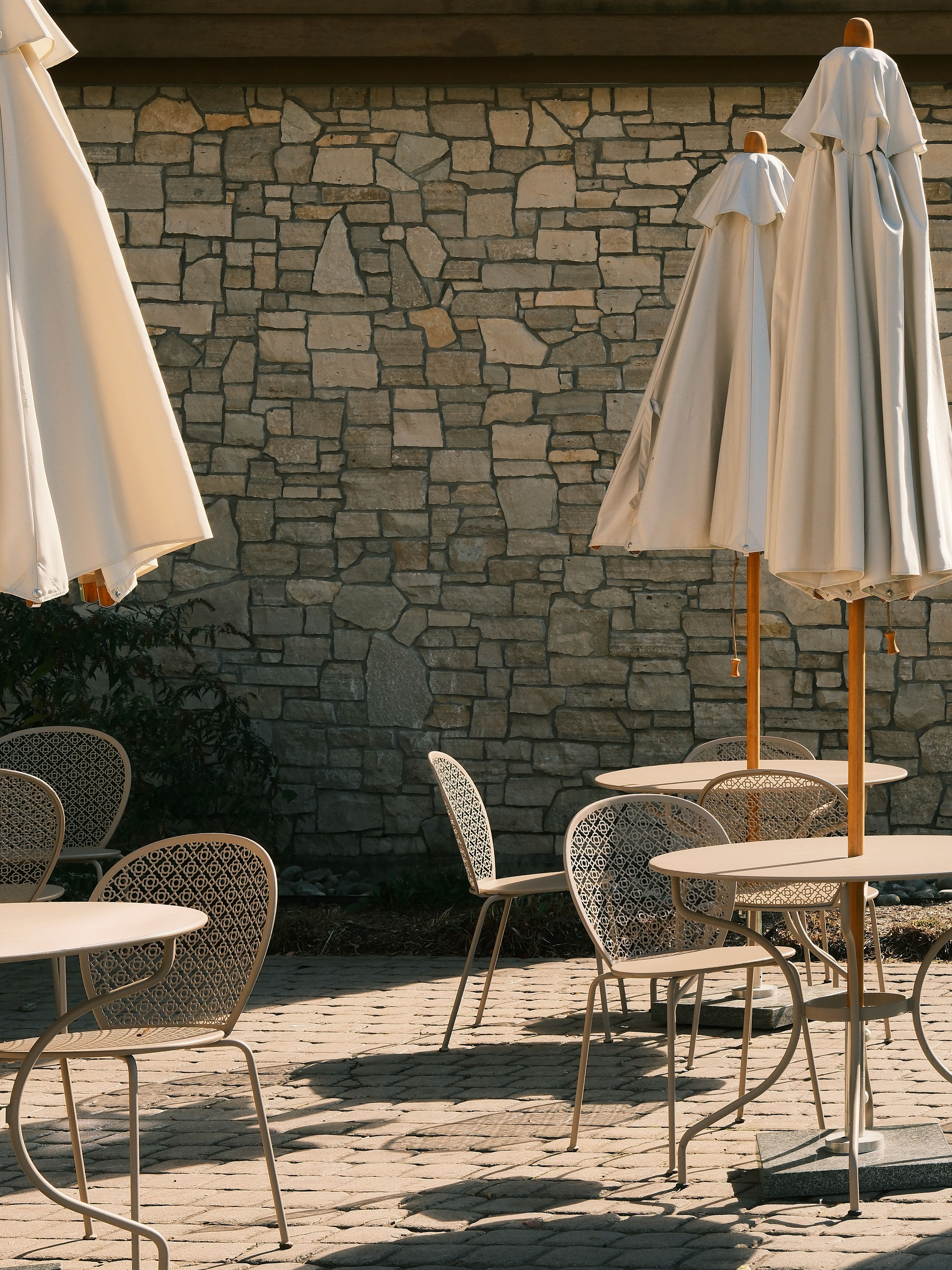 Empty Outdoor Cafe with Closed Umbrellas · Free Stock Photo