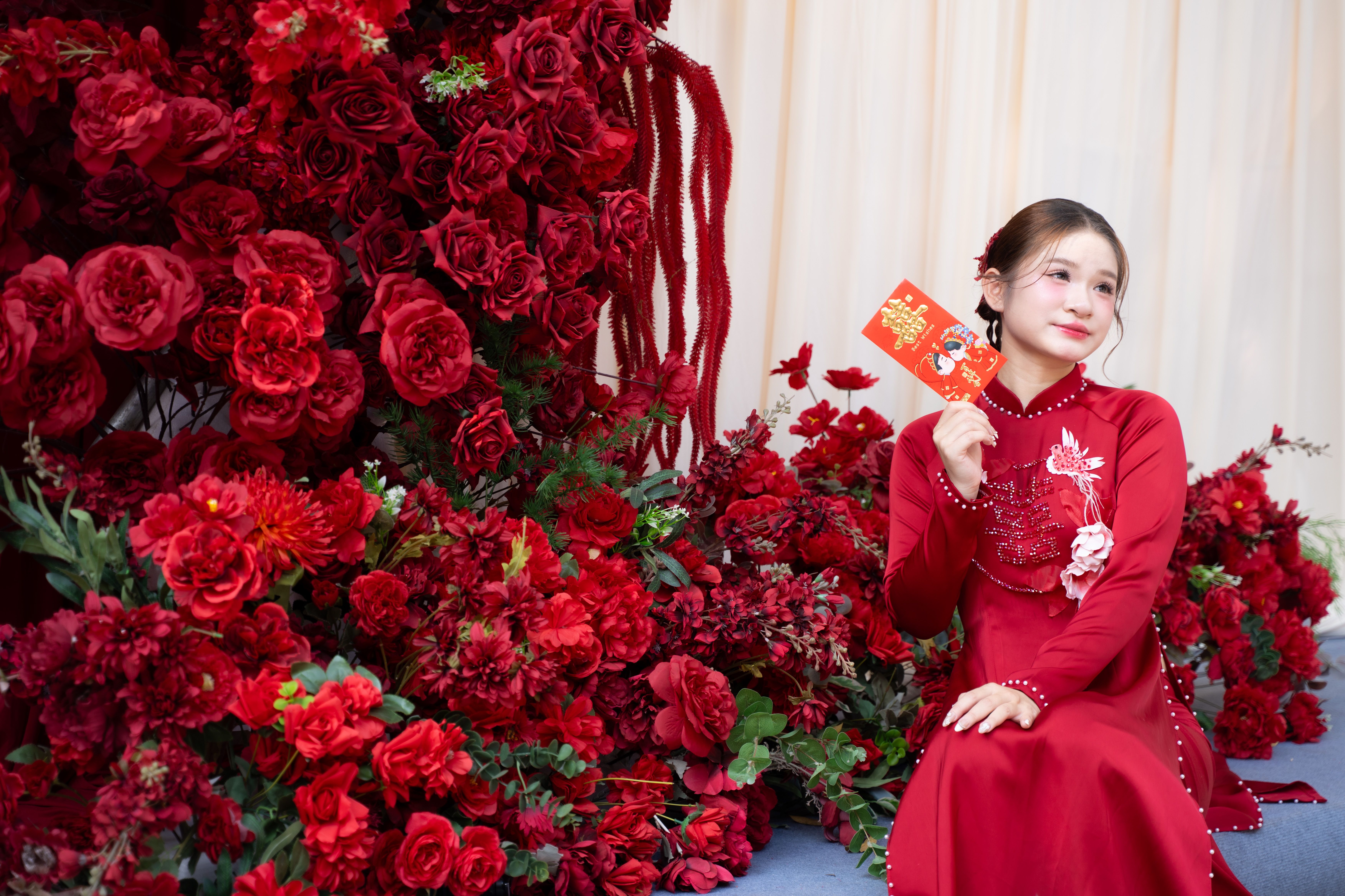 Young Woman Celebrating Lunar New Year with Red Roses · Free Stock Photo