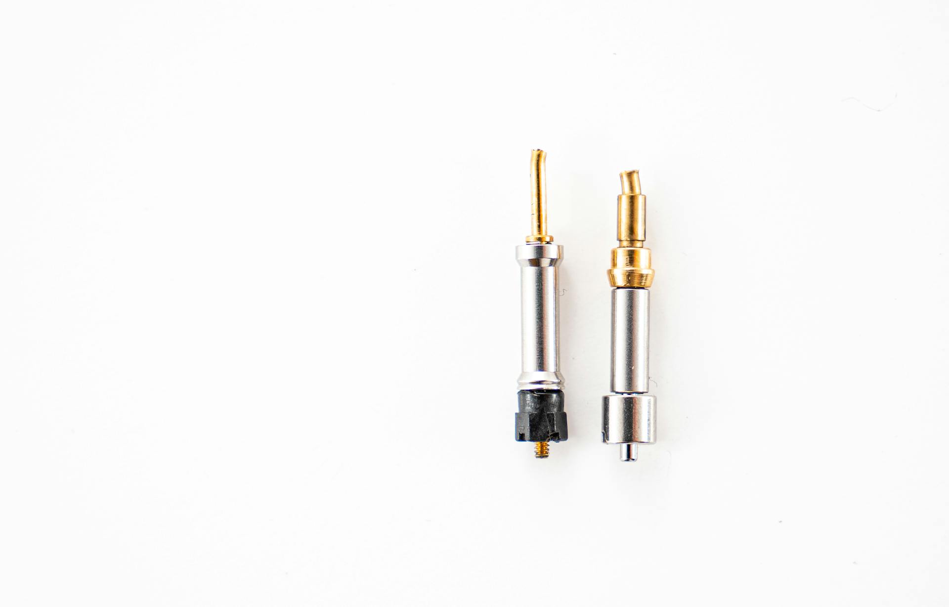Two metal connectors placed against a clean white background.