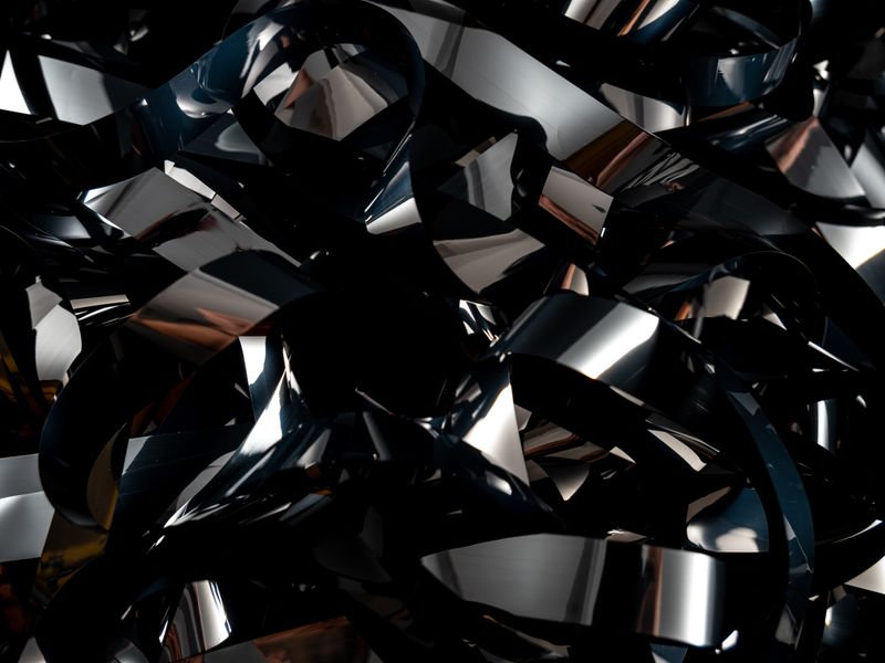 Abstract twisted black metallic ribbons — photo by Dan Cristian Pădureț on Pexels