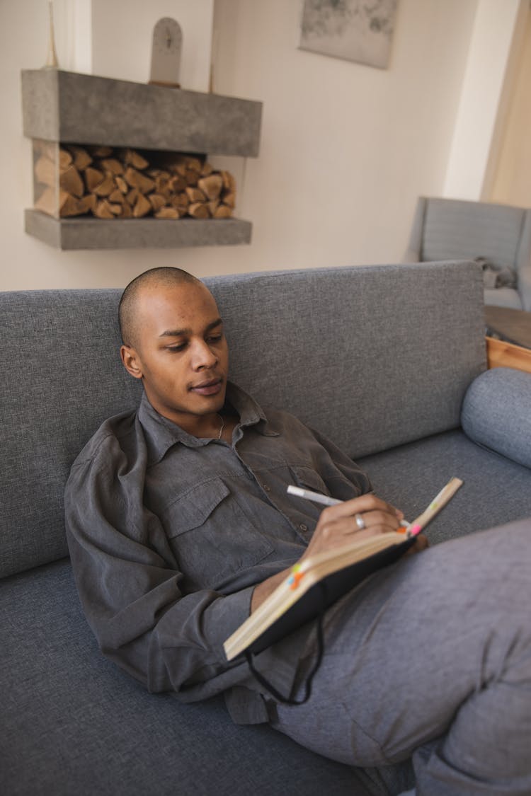 Photo Of Man Writing On A Notebook