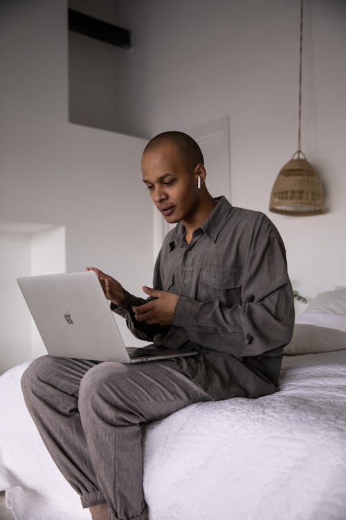 Free Photo Of Man Sitting On A Bed Stock Photo