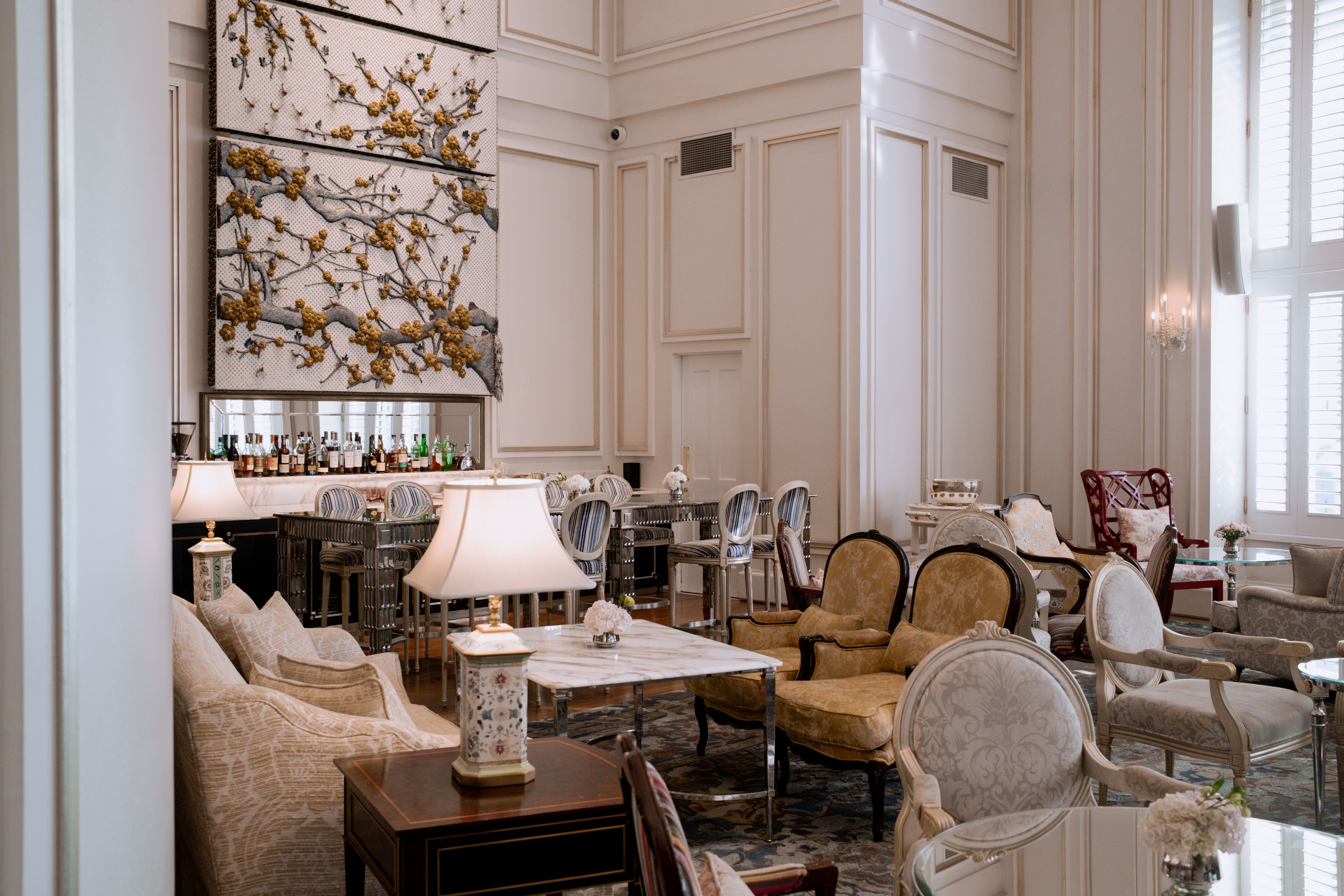 Luxurious lounge area featuring vintage furniture and elegant decor in soft lighting.