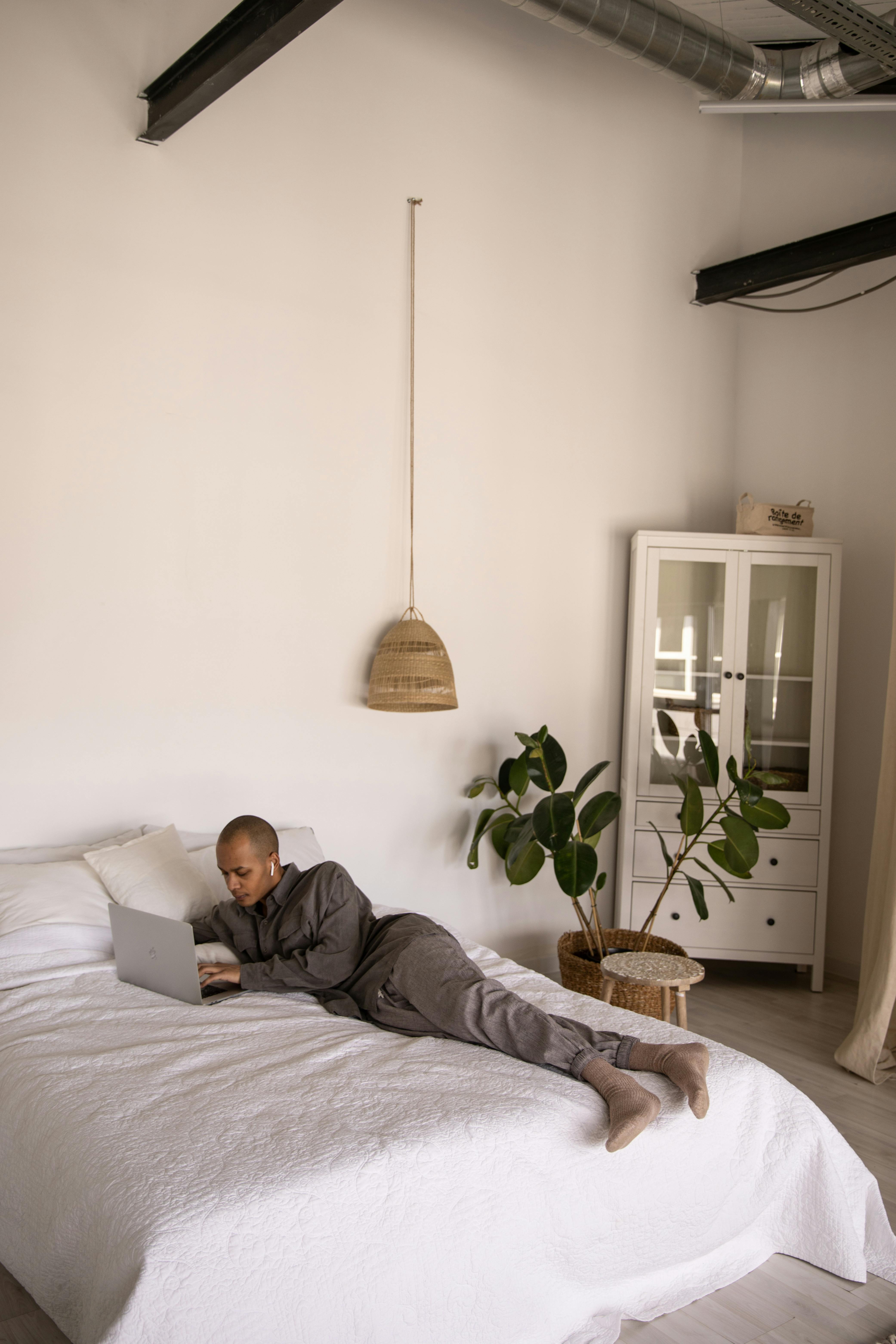 Photo Of Guy Laying On Bed · Free Stock Photo