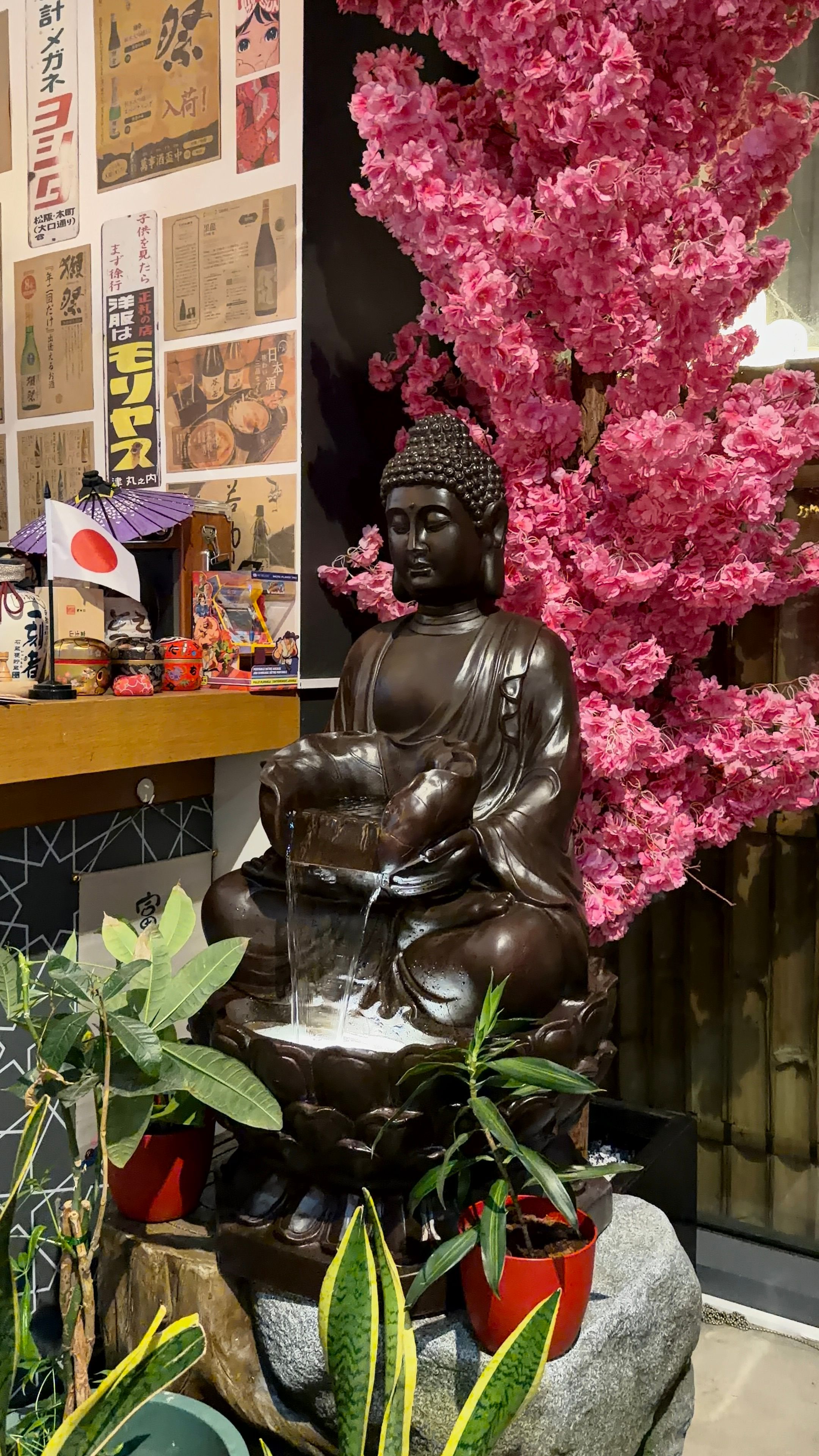 Buddha Fountain with Cherry Blossom Decor Indoors · Free Stock Photo