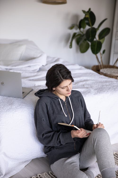 Photo Of Woman Writing On A Notebook