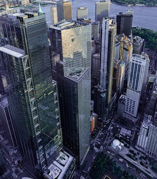 Stunning aerial view of New York City's skyscrapers with a river backdrop, showcasing urban architecture.