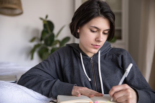 Free Photo Of Woman Writing On A Notebook Stock Photo