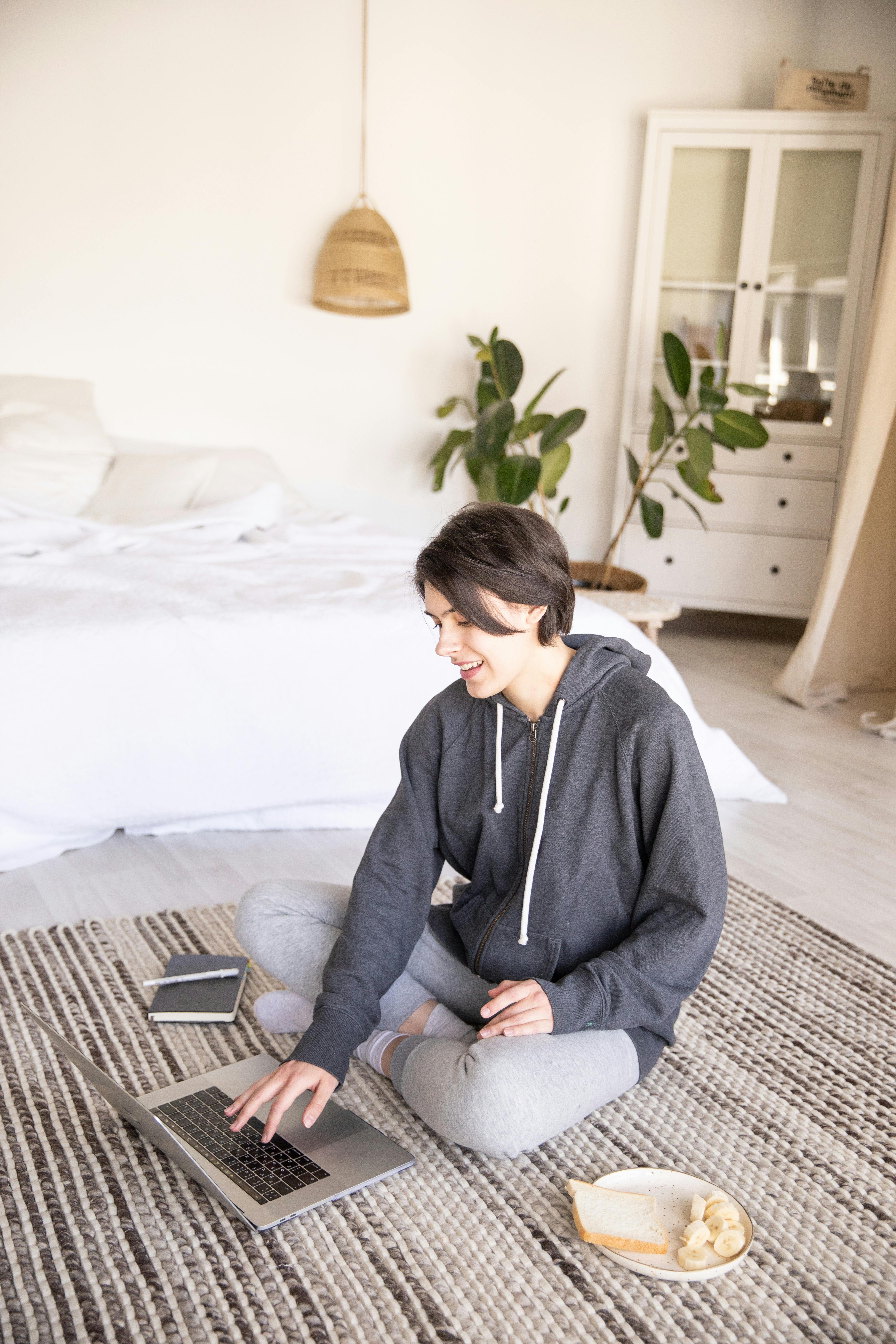 young woman using laptop on floor