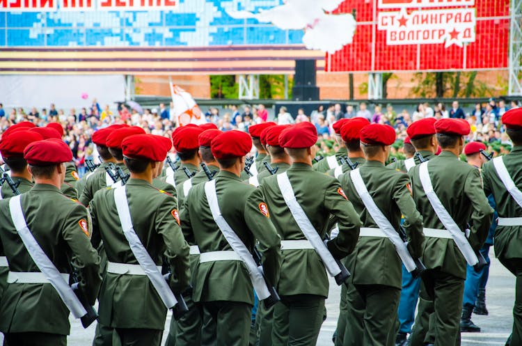 Group Of Man Wearing Green Uniform Falling In Line