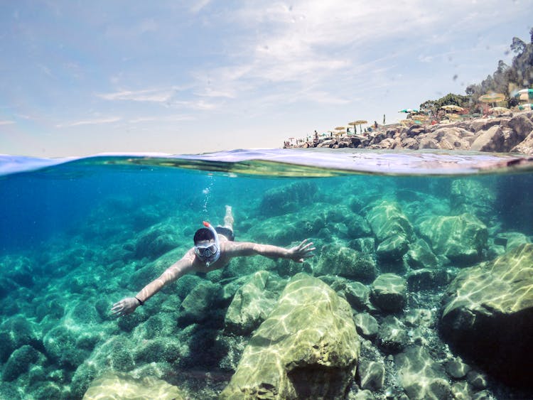 A Man Using Snorkel Under The Water