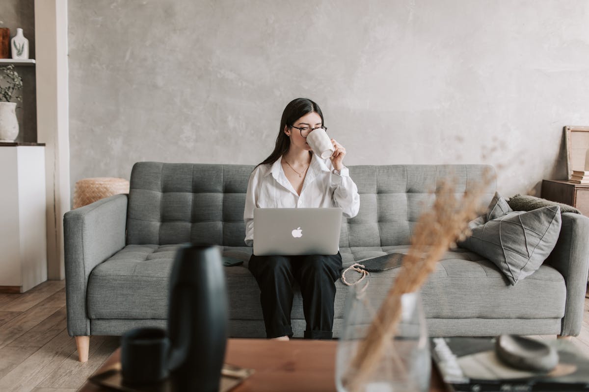 Woman Drinking Coffee While Working With Laptop writing reply to divorce letter