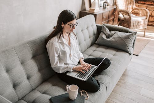 Free Woman Working At Home Using Laptop Stock Photo