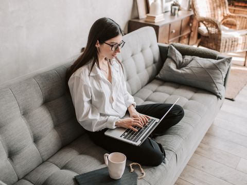 A person working remotely on a laptop at home