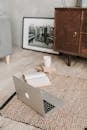 Laptop and books on floor carpet