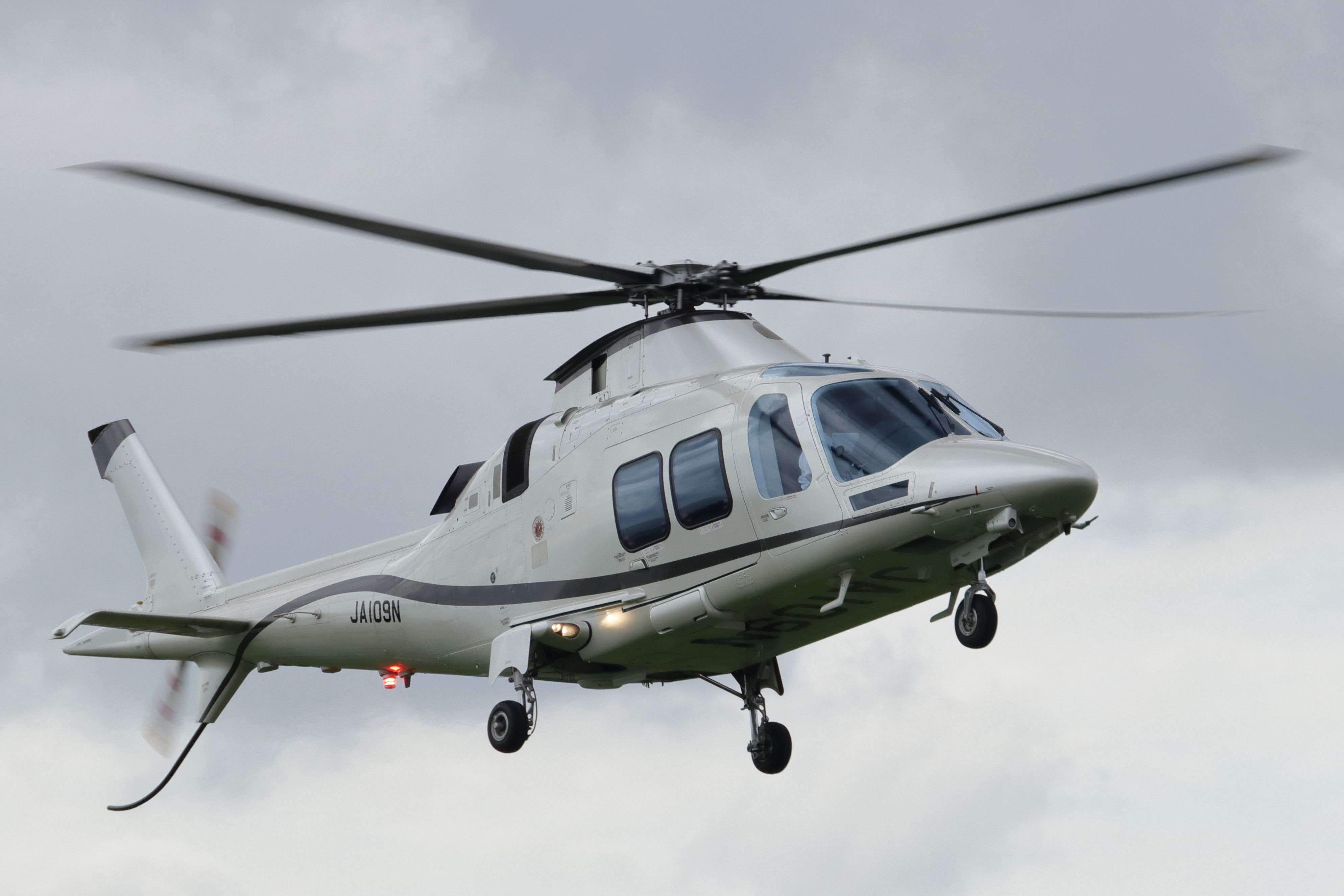 Helicopter Mid-flight Against Cloudy Sky · Free Stock Photo
