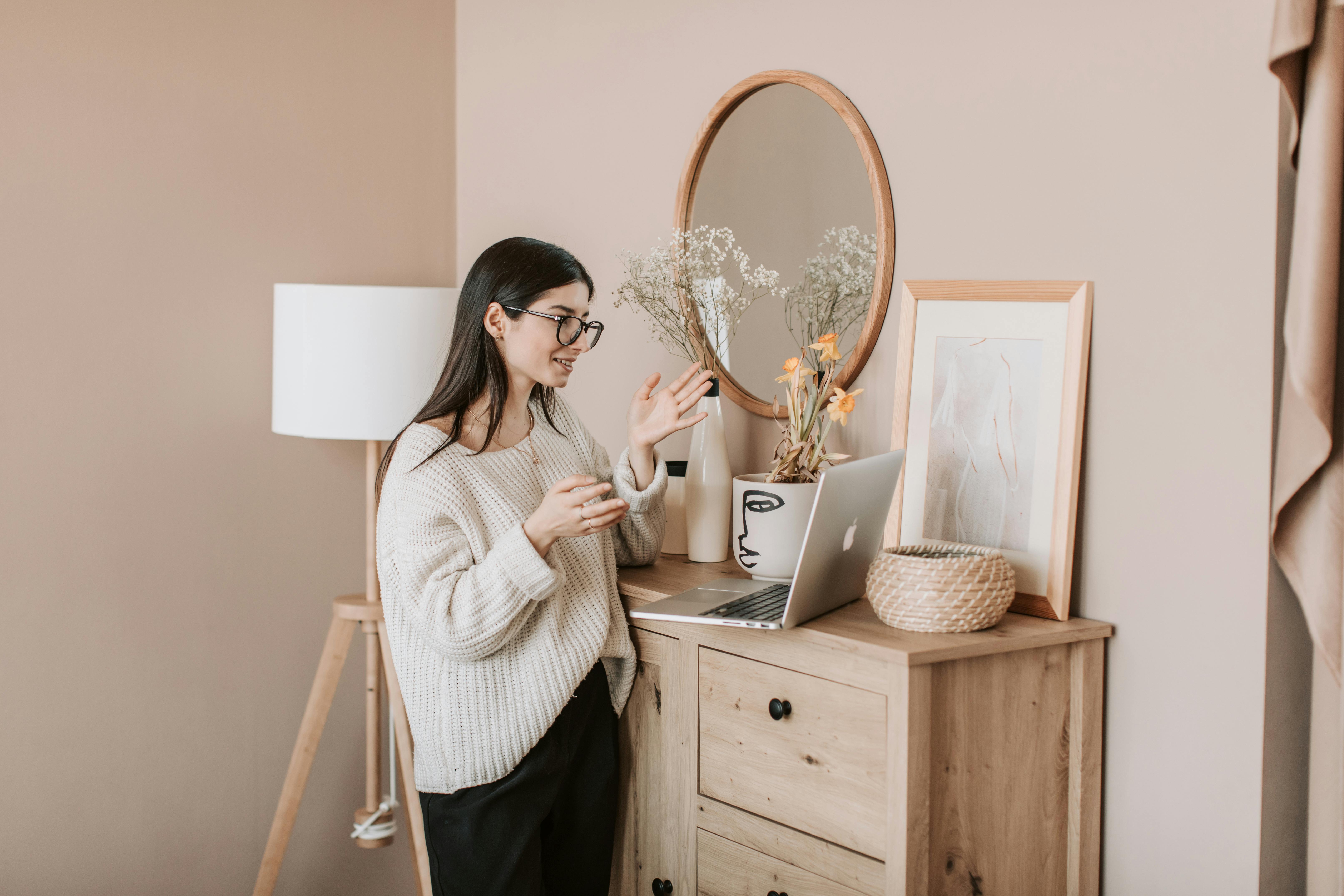 young woman talking via laptop at home