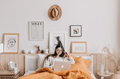 Free Woman Using Laptop In Bed Stock Photo