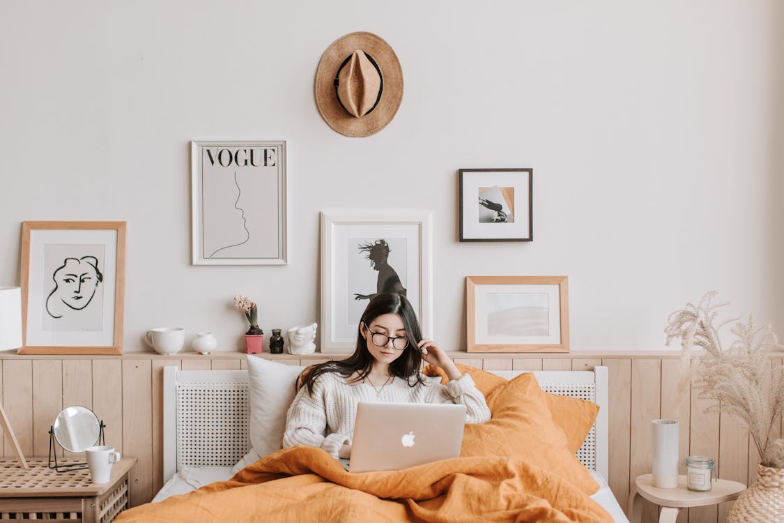 Free Woman Using Laptop In Bed Stock Photo