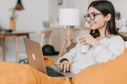 Free Woman Having Coffee While Using Laptop Stock Photo