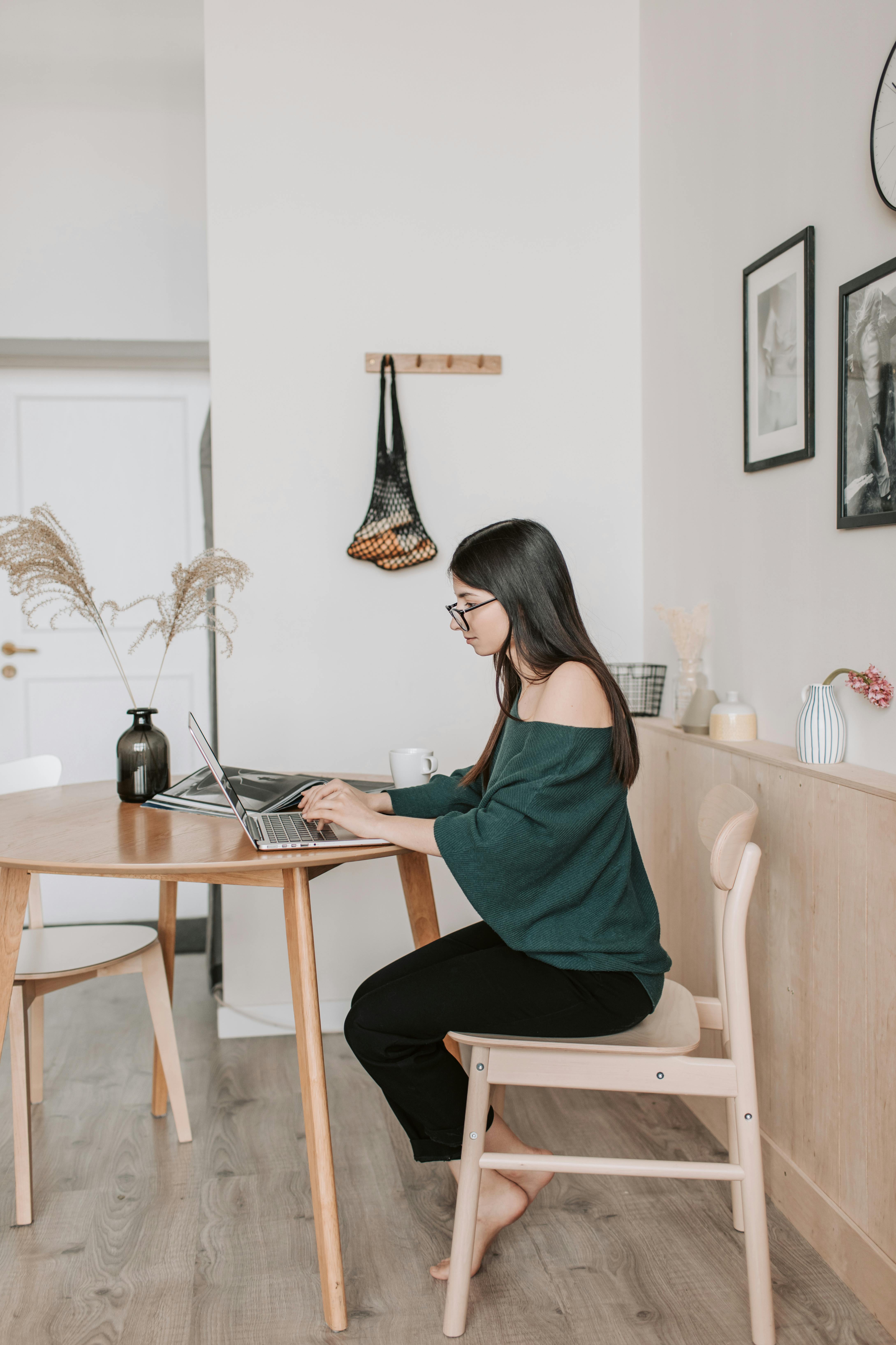 female remote worker typing on laptop at home