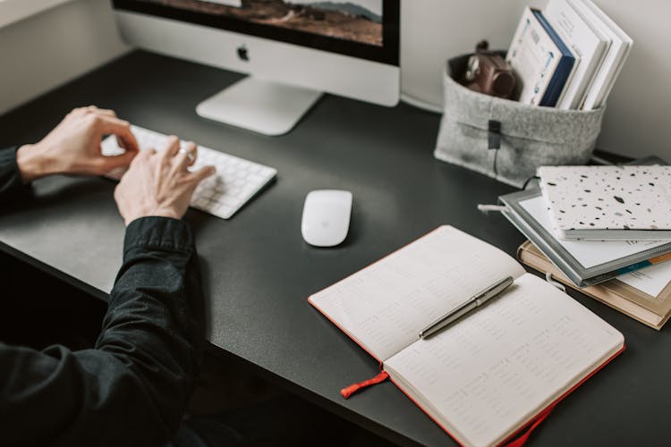 Photo Of Man Typing On Keyboard