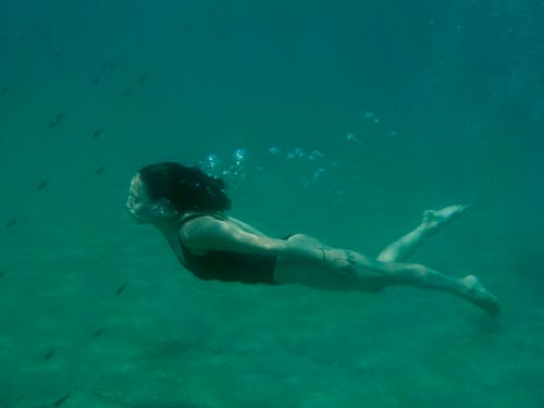 Photo Of Woman Swimming Underwater