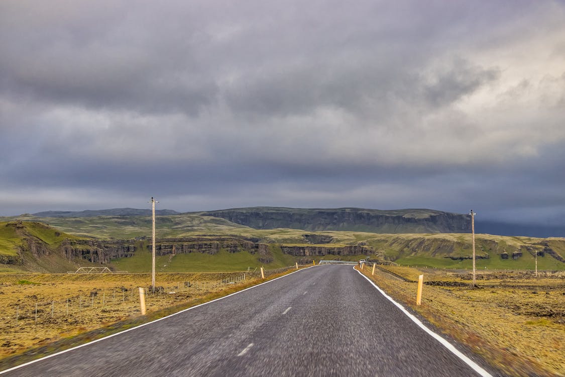 Photo Of Empty Road Under Cloudy Sky