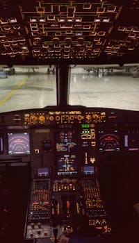 A captivating view of an illuminated modern airliner cockpit, showcasing advanced avionics and controls.