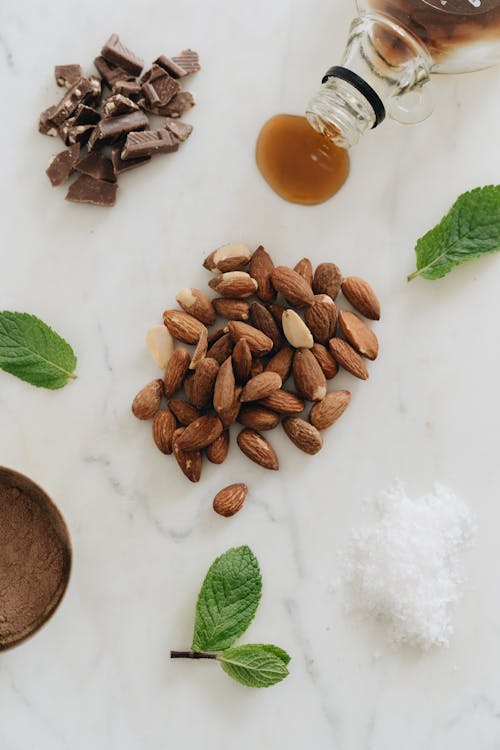 Photo Of Almonds Near Mint Leaves