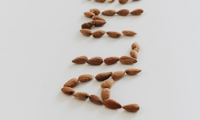 Amêndoas cruas espalhadas em close, mostrando a textura natural da semente