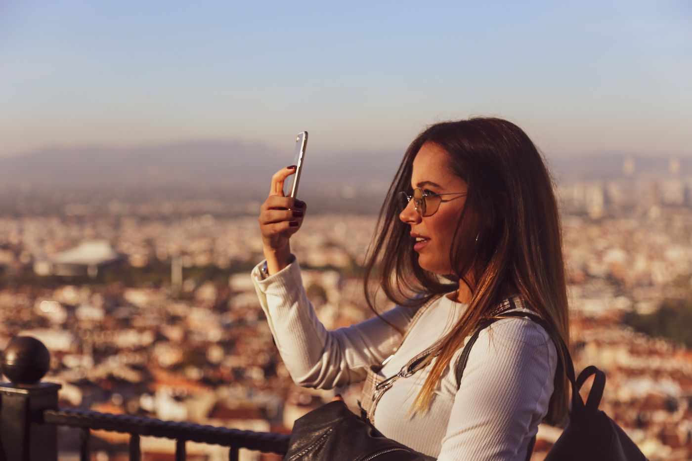 A traveler using a phone above a city