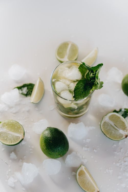 Free A cool mojito garnished with lime and mint leaves surrounded by ice cubes. Stock Photo