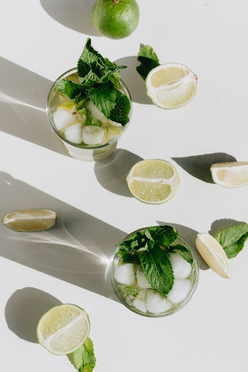 Photo Of Sliced Lime Beside Glass