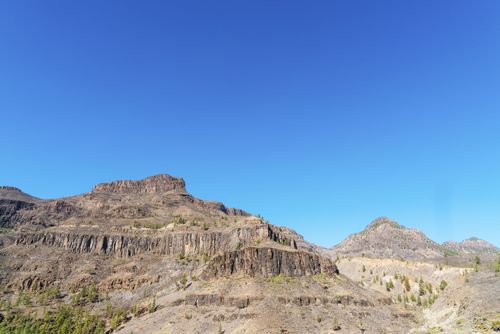 Free Stunning view of Grand Canyon-like rock formations against a bright blue sky, perfect for travel and nature enthusiasts. Stock Photo