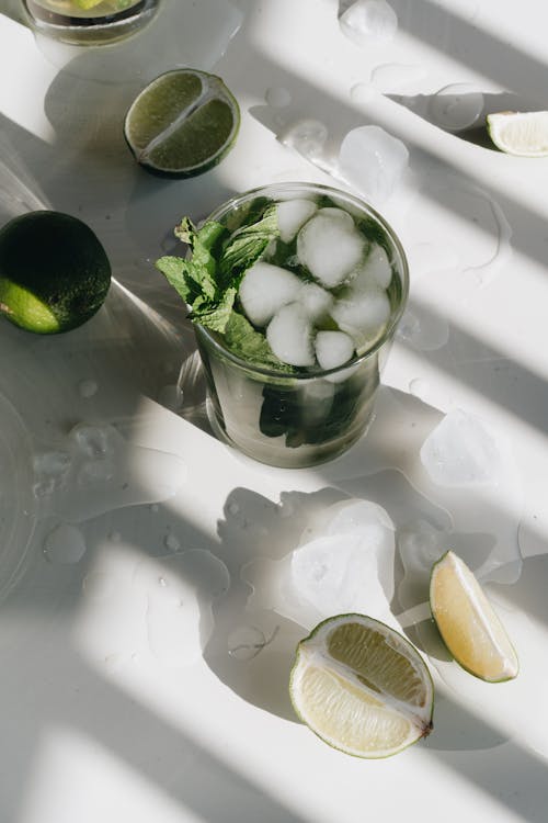 Photo Of Sliced Lime Beside Glasses