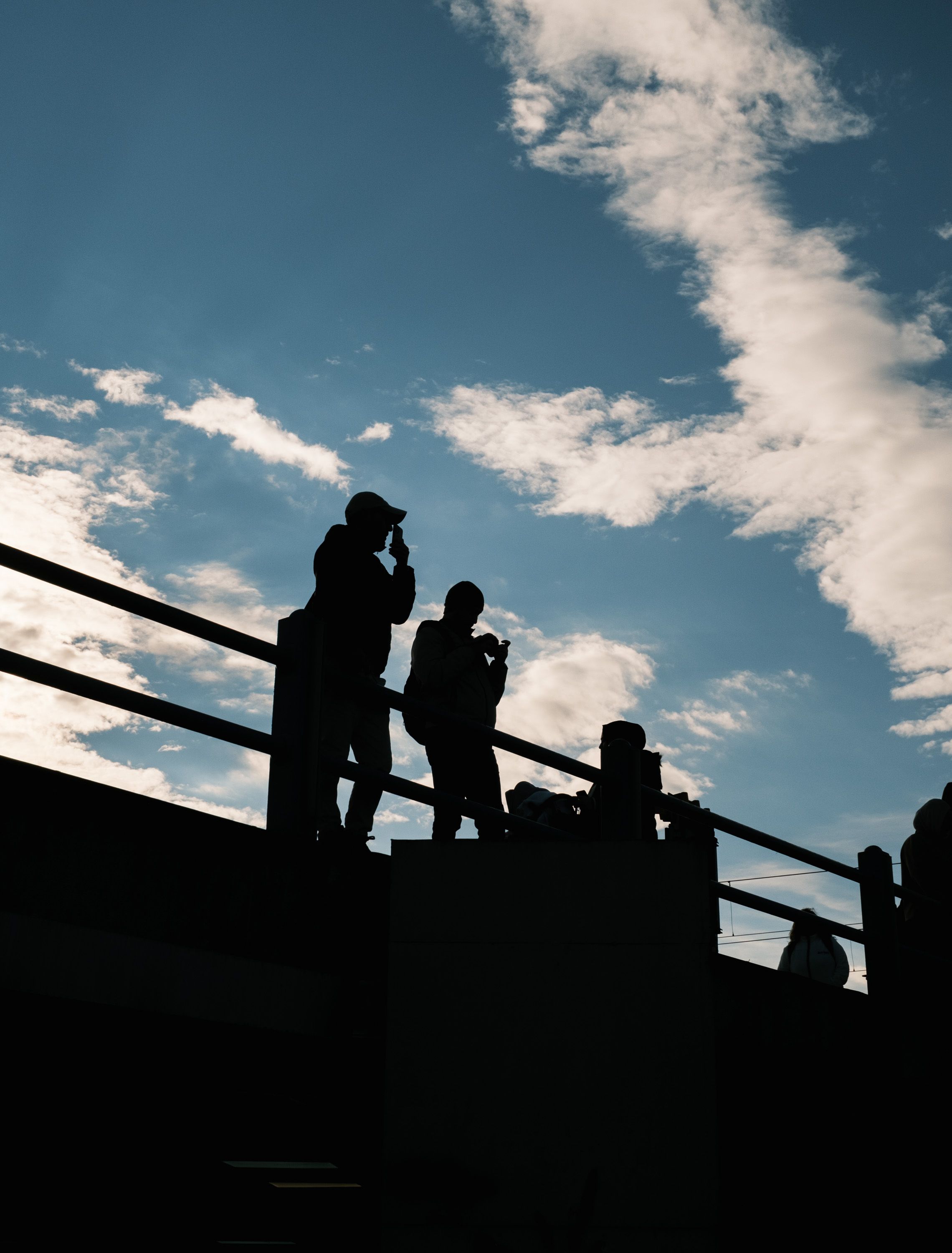 Silhouetted Figures on Istanbul Bridge at Dusk · Free Stock Photo