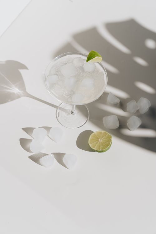 Free An aerial view of a refreshing lime margarita with ice, casting dramatic shadows. Stock Photo