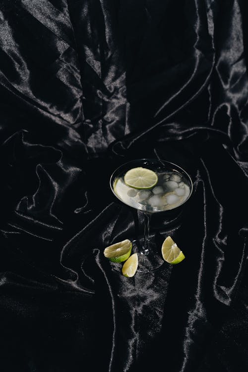 Photo Of Cocktail Glass On Black Silk Fabric