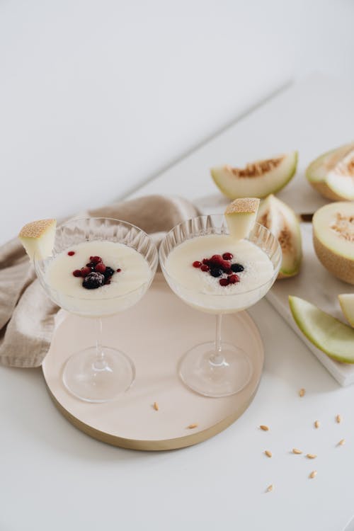 Photo Of Glasses Near Sliced Melon