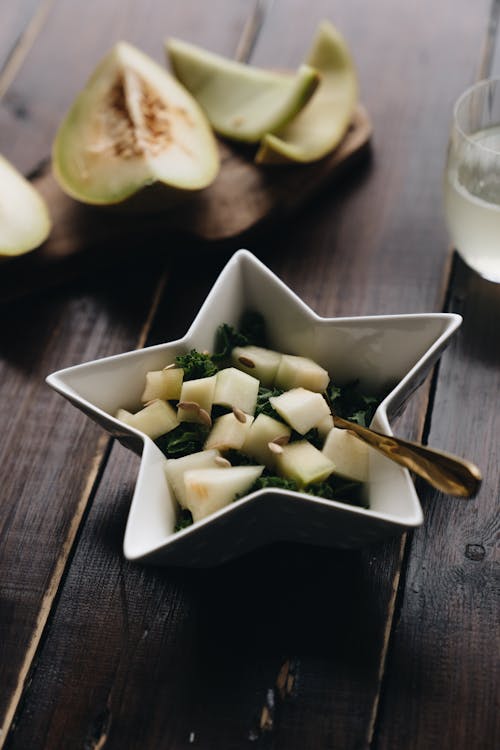 Free Photo Of Sliced Melon On Wooden Surface Stock Photo