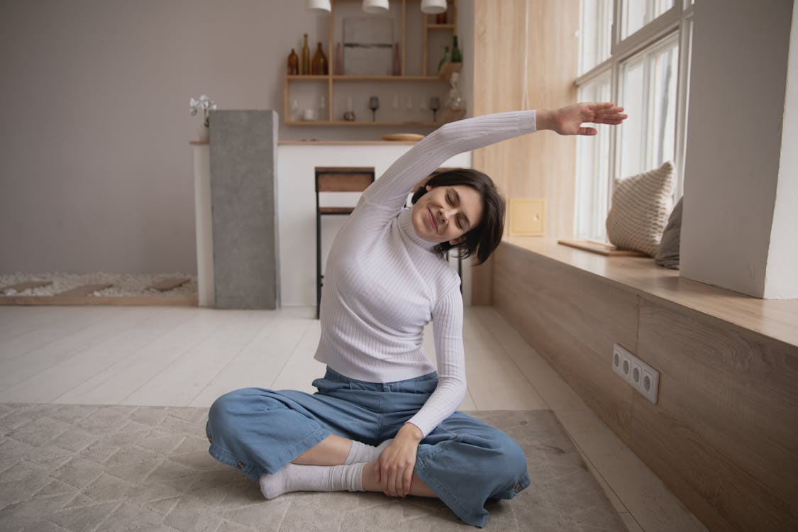 Free Smiling woman practicing yoga with closed eyes at home Stock Photo