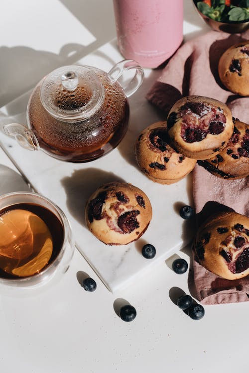 Photo Of Berry Muffins Beside Teapot