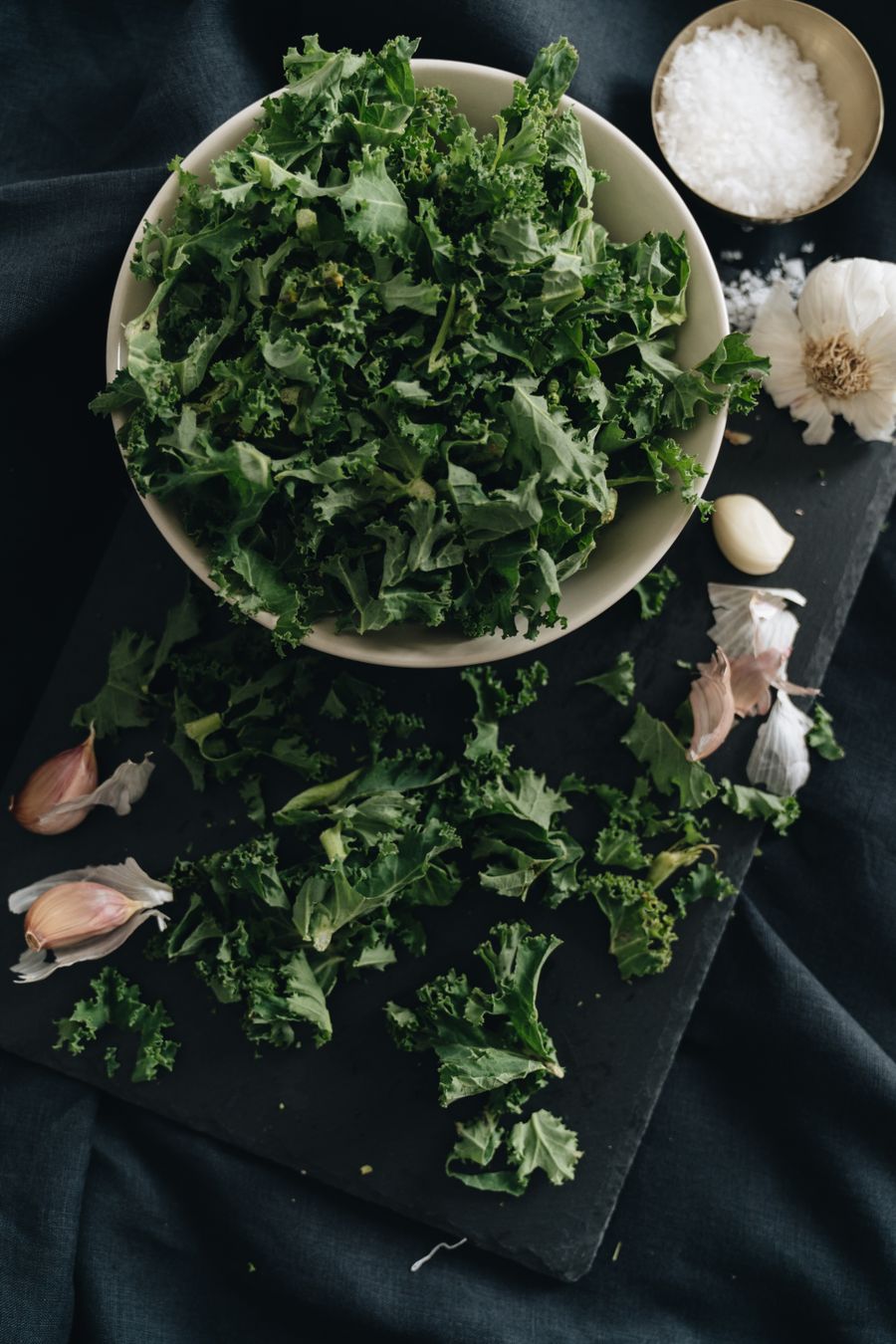 Fresh leafy herbs on a dark surface