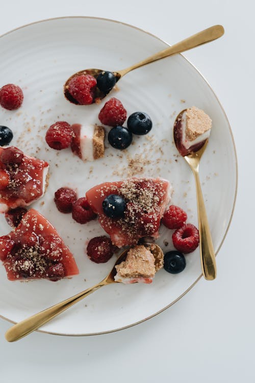 Overhead Shot of Cheesecake with Fruits Near Gold Spoons