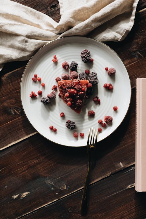 Sliced Cheesecake on White Ceramic Plate